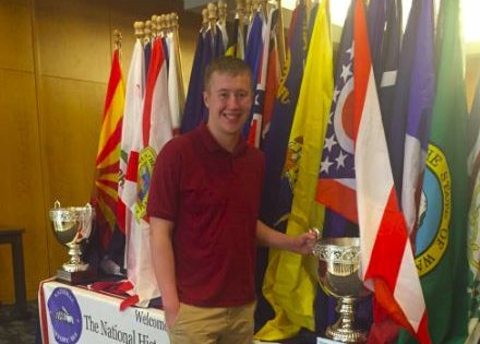 Junior Peter Blanchfield poses with the awards table at the National History Bowl.