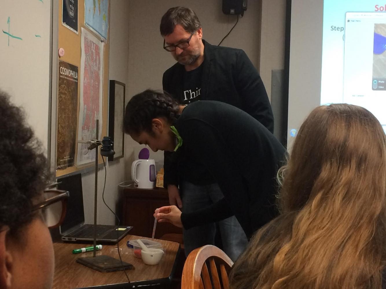 Senior Shefali Bijwadia stains a titanium dioxide coated chip with crushed raspberries to make a solar cell in University of Minnesota professor Ted Pappenfus’s session. 