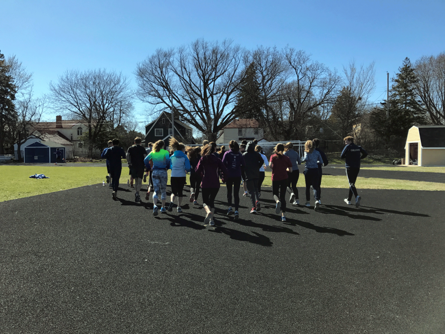 Runners begin their warm-up at practice.