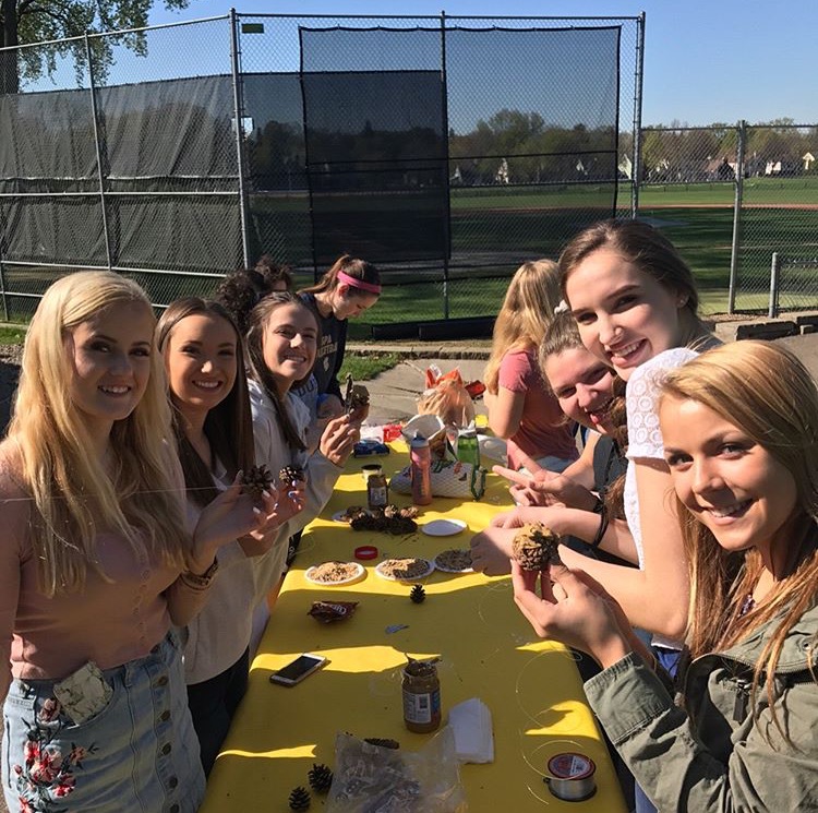 Members of CAS gather outside to make bird feeders. "We wanted to do more things that we could physically do...during the club, and we thought making bird feeders would be engaging,” junior co-president of CAS Sophia Rose said.