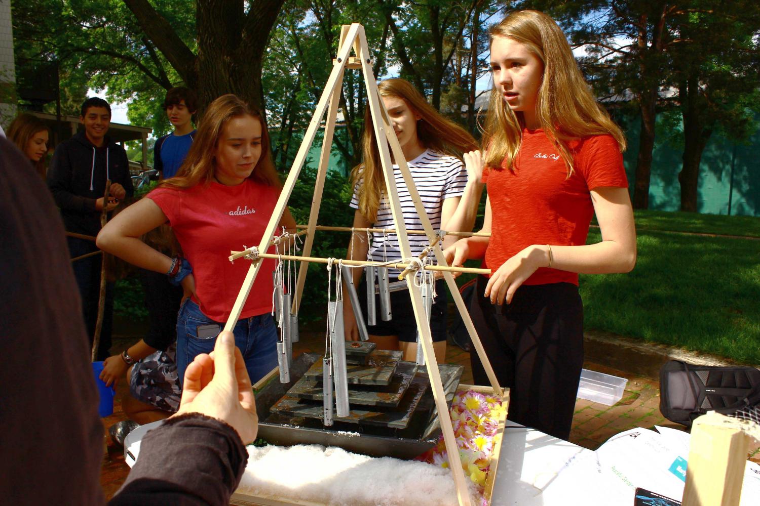 9th graders Masha Ames, Martha Sanchez, and Lauren Dieperink examine a waterfall sculpture.