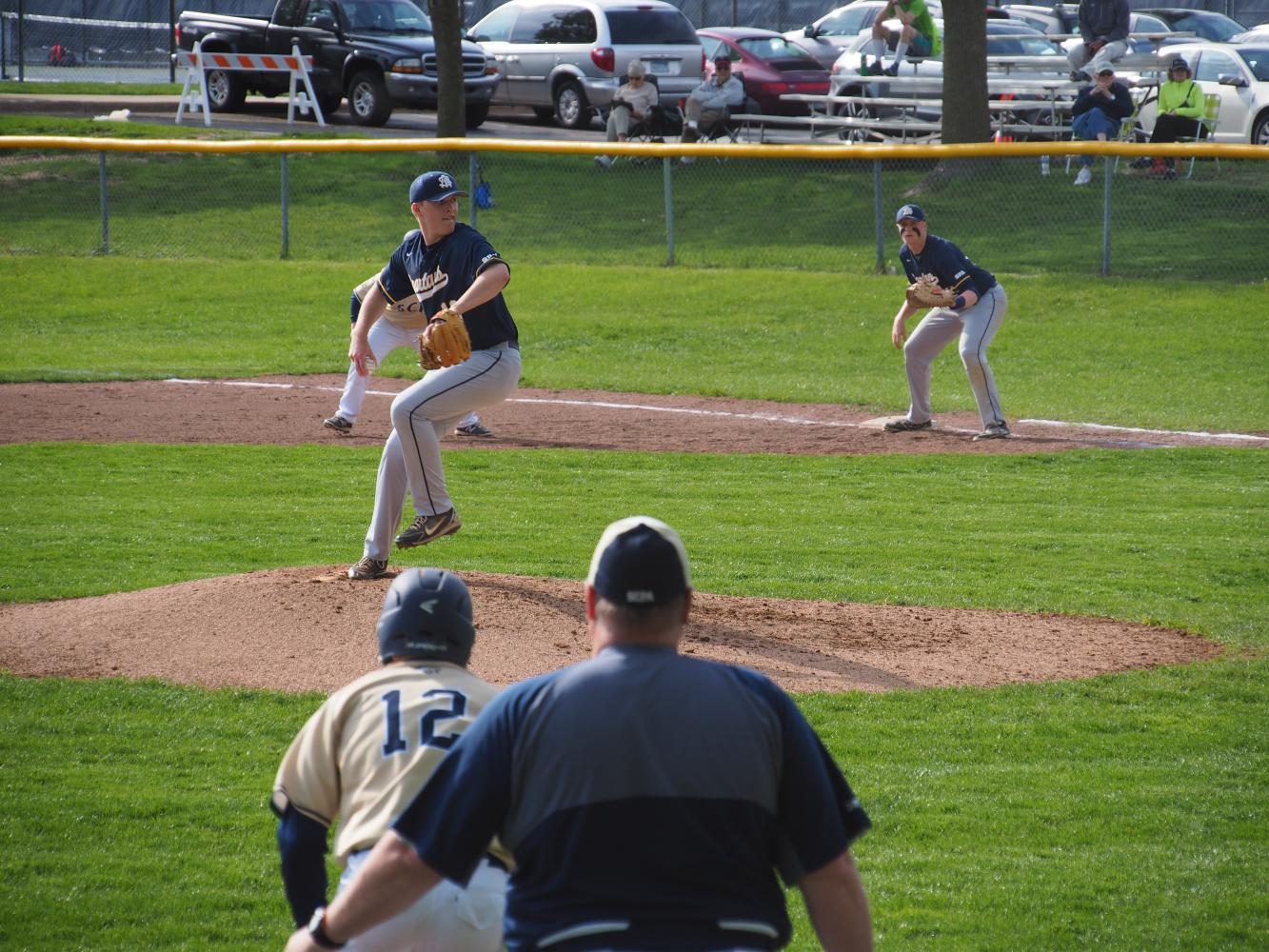 Senior Emerson Egly winds up to throw home in a game against Providence Academy. Egly has over 30 strikeouts this year and leads the Spartans in RBIs.