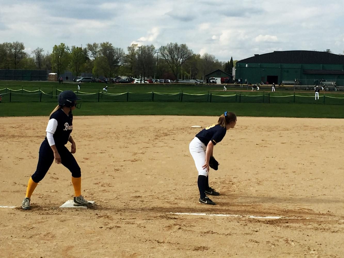 Senior third baseman Justine Miller holds a Breck player on base in the third inning.