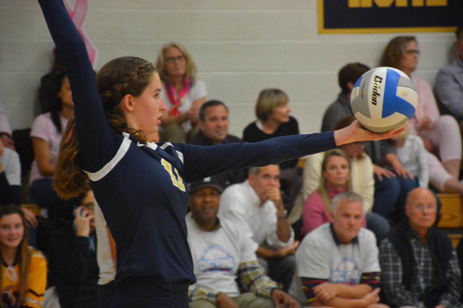 Junior Blythe Rients prepares to serve during a volleyball game. "I really hope to go far in sections this year with the team, and compete to try to go to state. I will do whatever possible to do my job and help the team," Rients said.