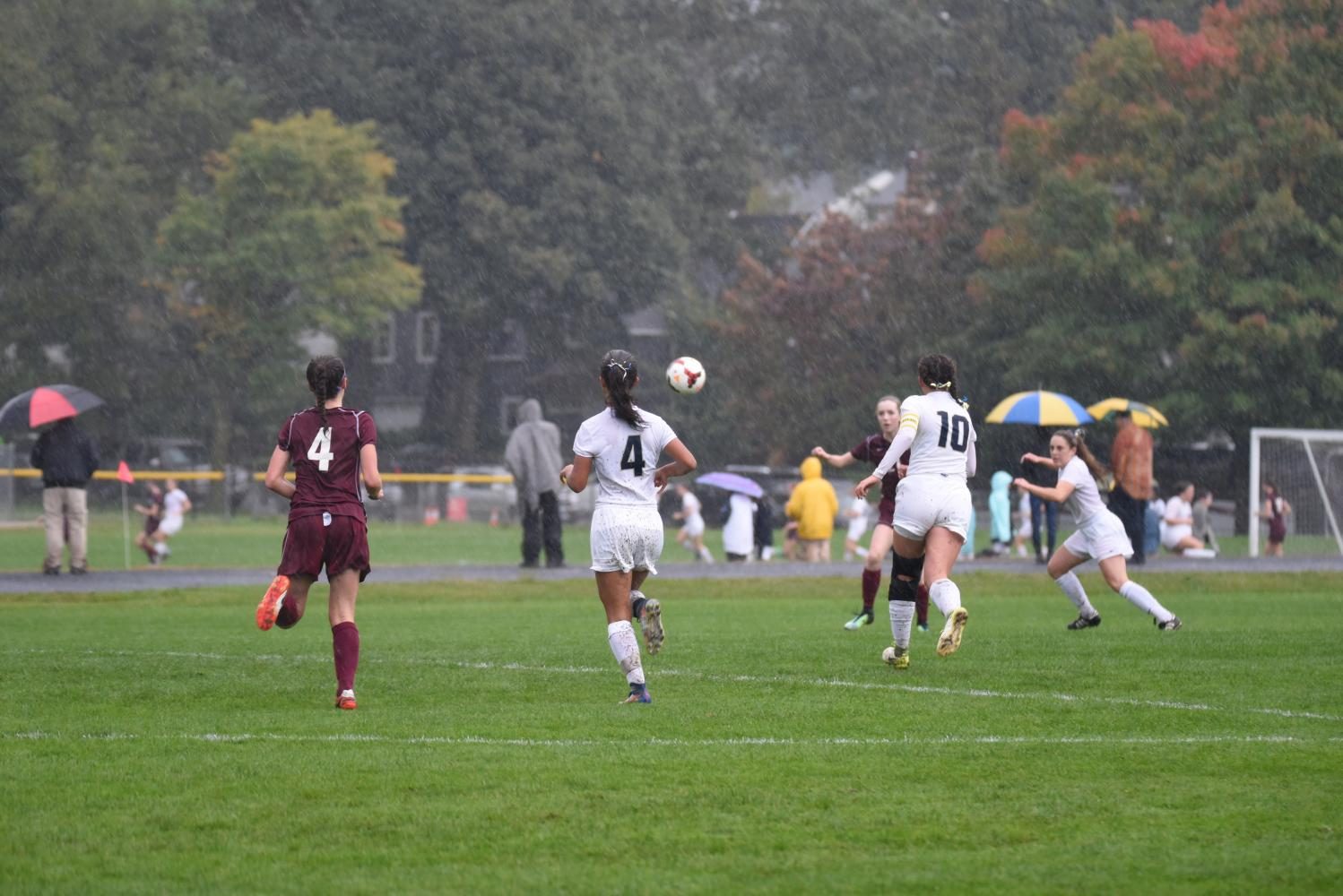 The Spartan players pounce on a loose ball.