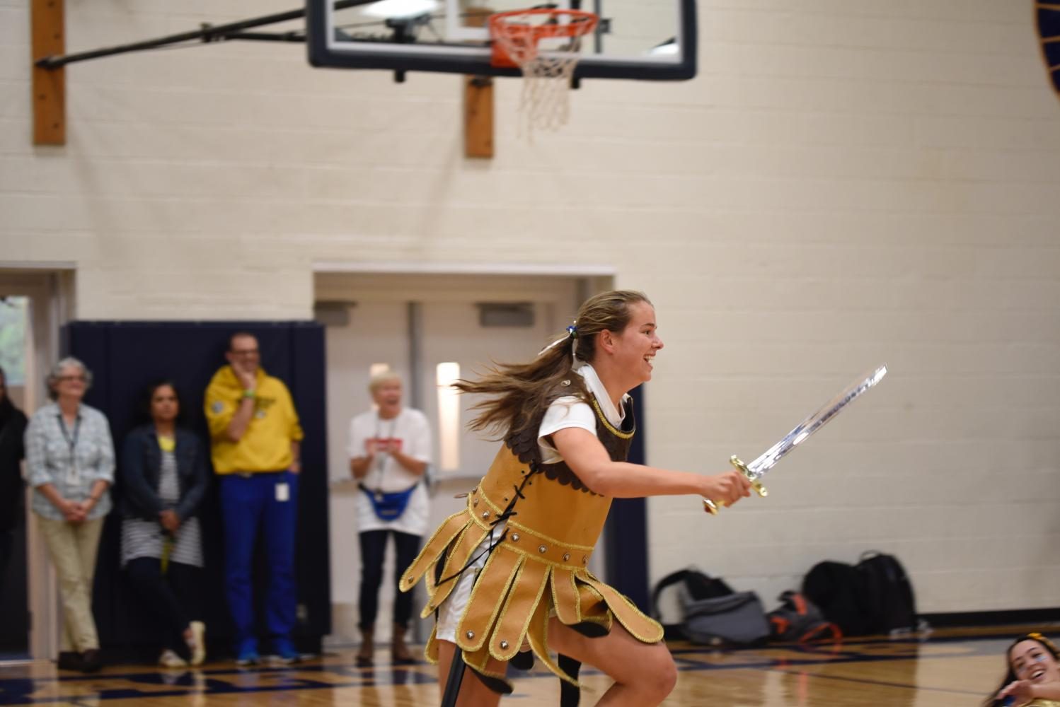 Senior and Spartan Kelly Fiedler runs in a skit performed by other students. 