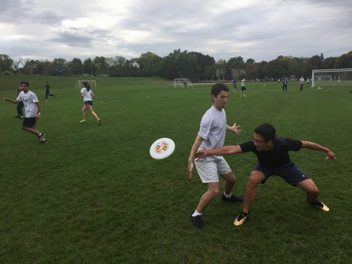 Senior Larry Chen gets low and throws the frissbee to a teammate. 