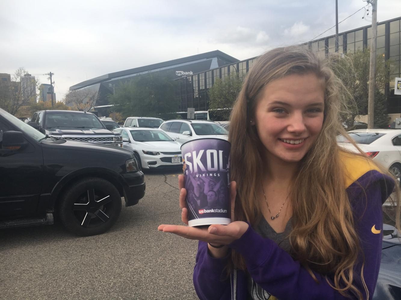 Junior Kaia Larsen poses with her souvenir Vikings cup in front of the US Bank Stadium after the Oct. 15 game. I started watching the [Vikings] games on Sundays with my dad when I was in third grade, and since then Ive loved the Vikings, Larsen said.