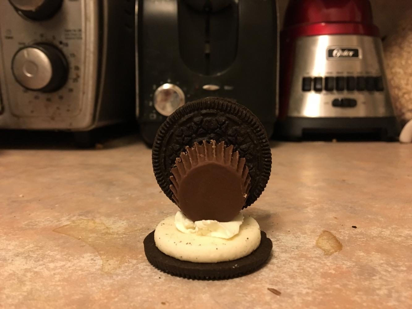 Step 3. Attach another Oreo cookie to the wide base of the peanut butter cup. 