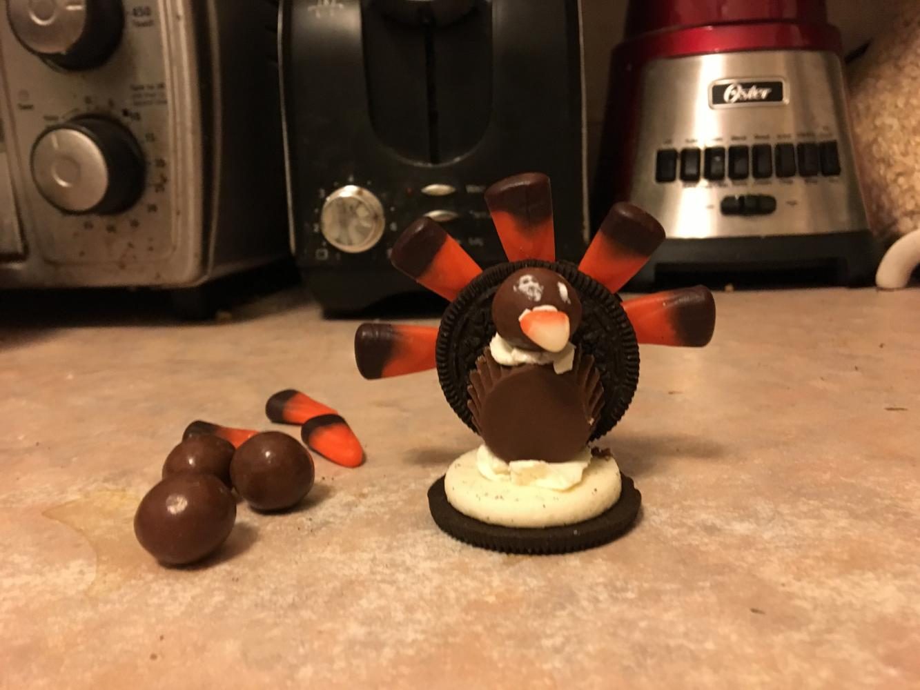 Step 6. Adhere a gummy candy "nose" to the Whopper using frosting. The tip of a candy corn was used for this recipe. 
