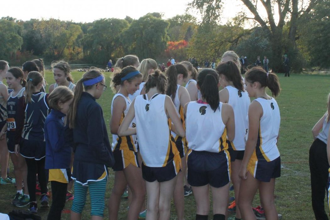 The Cross Country team comes together in a huddle before the race.