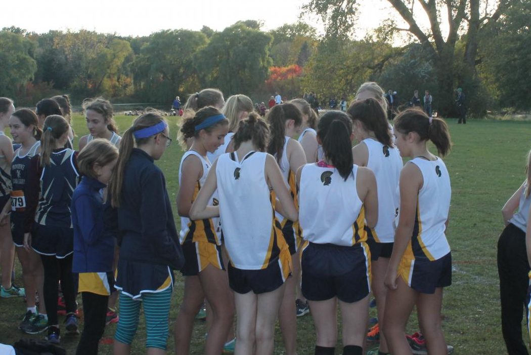 The Cross Country team comes together in a huddle before the race. 