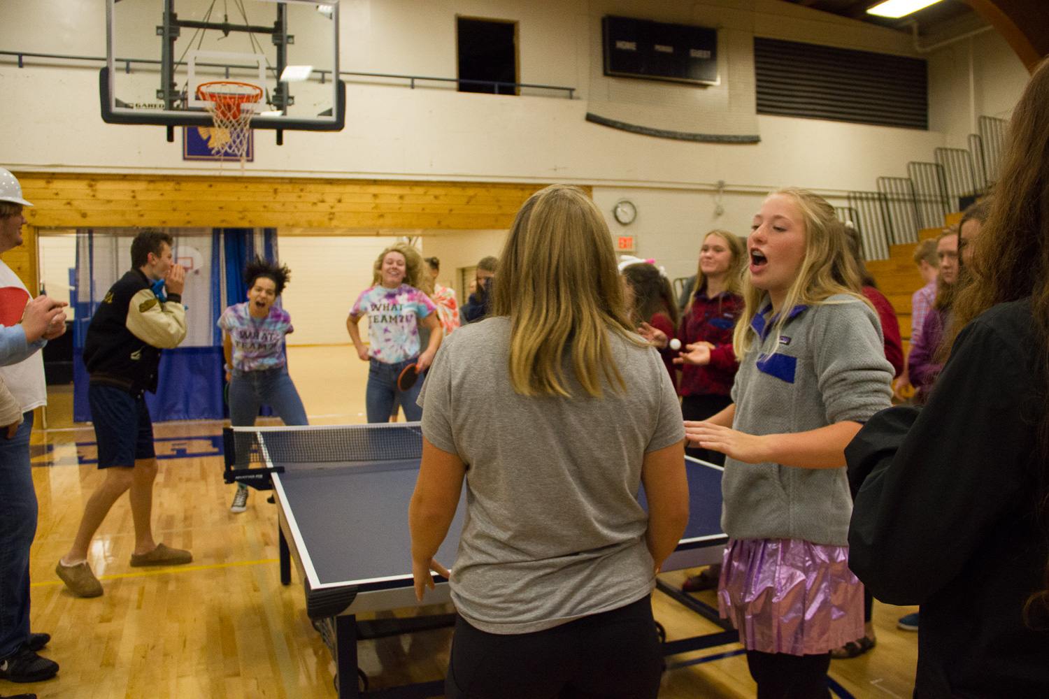 Sophmores Pia Shultz and Katherine Beran discuss strategy play while their opposing team celebrates winning a point.