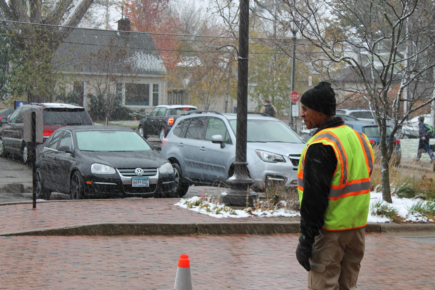 A security officer waits outside in the morning to monitor the traffic and safety of the students.