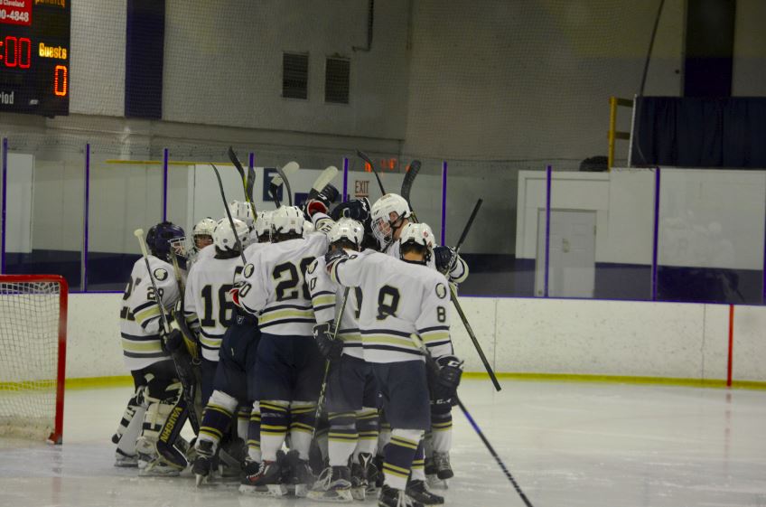 The Boys Hockey team huddles in Drake. “For [the Boys Hockey team], it’s kind of like a collection of memories," Boys Hockey captain Adam Zukowski said.