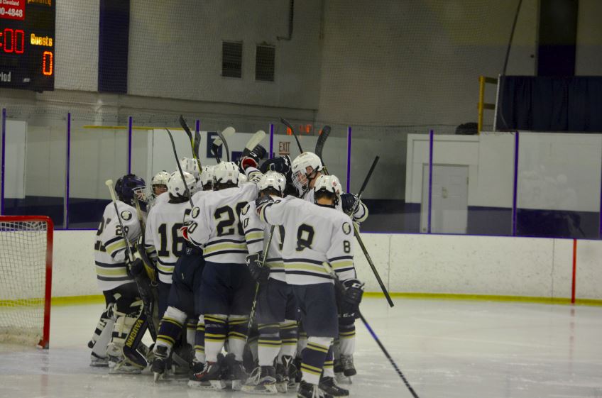 The Boys Hockey team huddles in Drake. “For [the Boys Hockey team], it’s kind of like a collection of memories, Boys Hockey captain Adam Zukowski said.