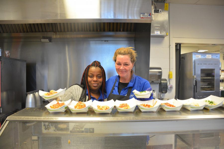 Tamika Daneil and Dawn Vraa prepare to hand food to the lunch line. Fellow lunch staffer Bailey Hayden noted, “My favorite thing [about my job] would be talking with the kids and the teachers…knowing that I made someone’s day.