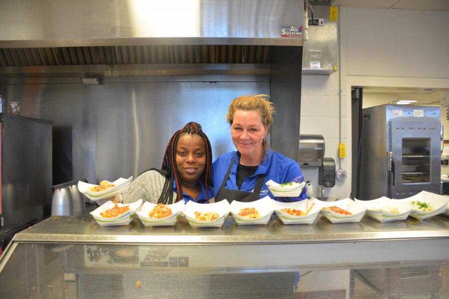 Tamika Daneil and Dawn Vraa prepare to hand food to the lunch line. Fellow lunch staffer Bailey Hayden noted, “My favorite thing [about my job] would be talking with the kids and the teachers…knowing that I made someone’s day."