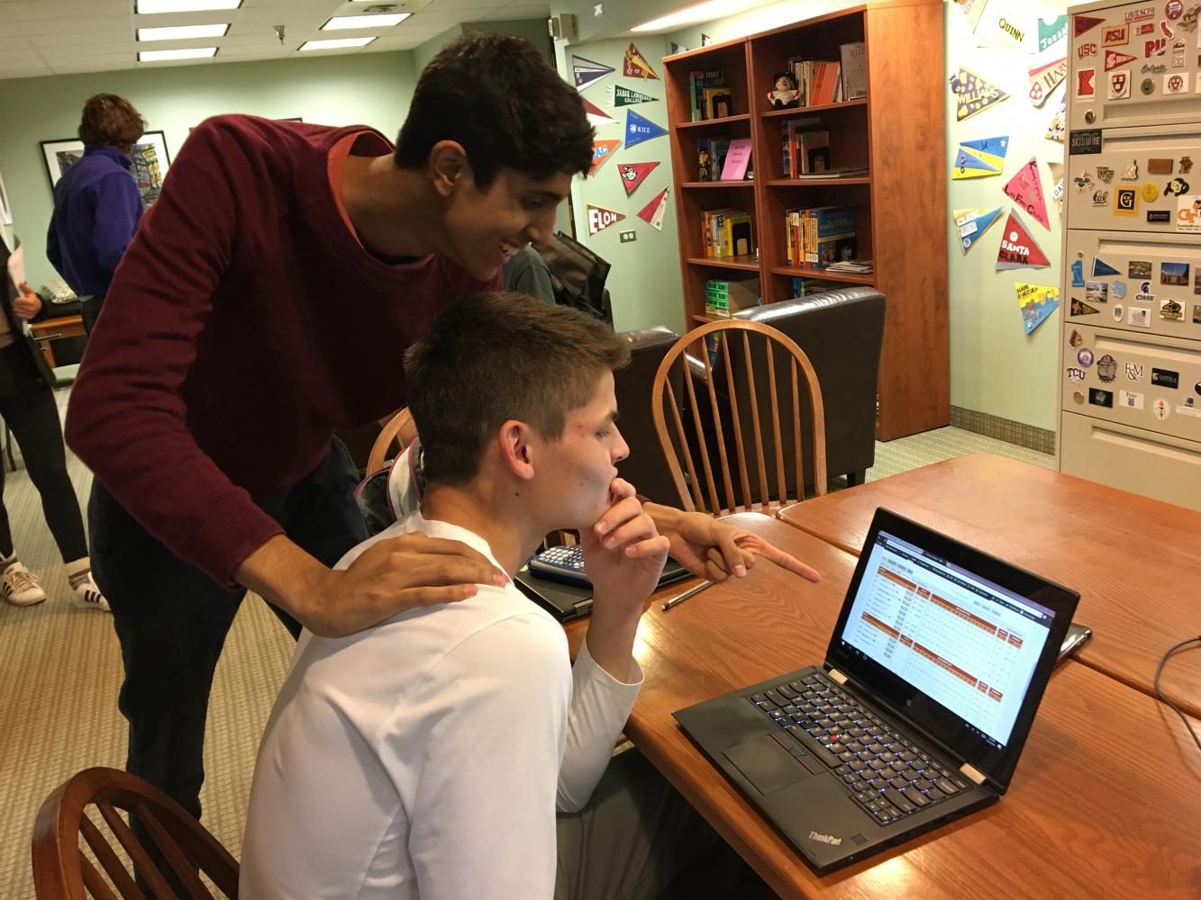 Seniors Rahul Dev and Gus Grunau study Grunau's fantasy basketball team's points for the week. “People say my team is bad when they hear the names. They aren’t big names, but on paper and with my managerial skills, I am feeling confident for this season,” Grunau said.