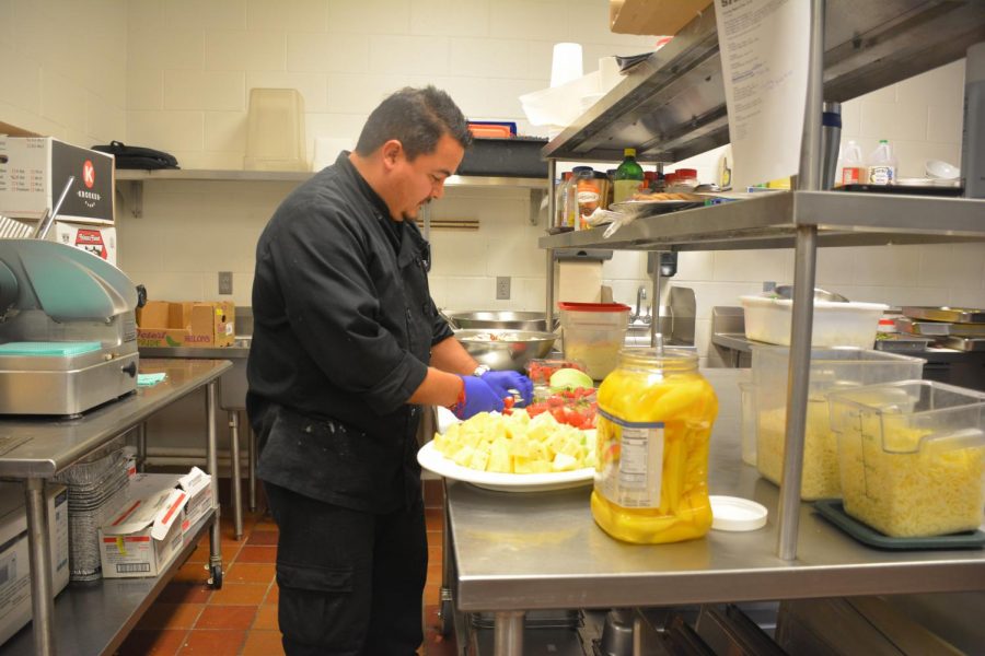 Emilio Candia slices strawberries for a fruit salad.