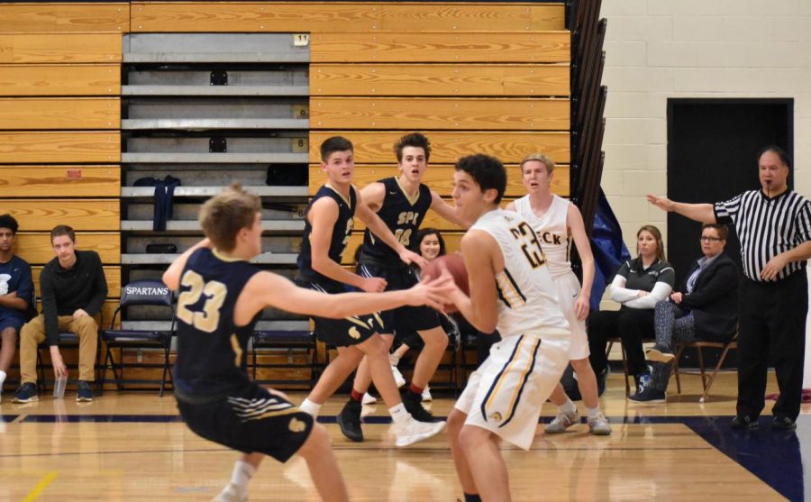 Adam Holod, Gus Grunau, and Nik Elsaesser try to get the ball back on the Breck end.