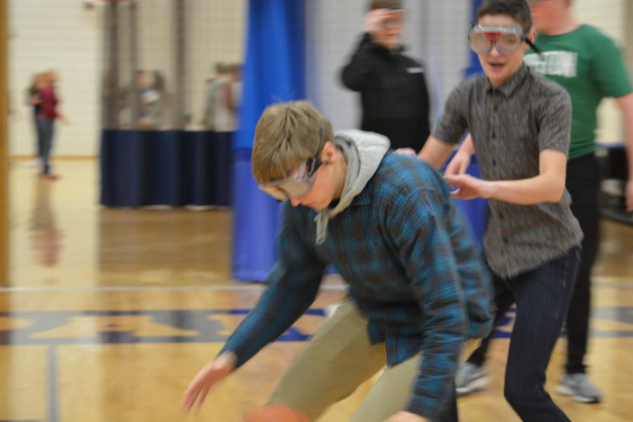 Junior Andrew Johnson fights for the ball during the drunk goggle course. 