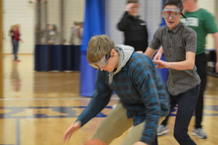 Junior Andrew Johnson fights for the ball during the drunk goggle course.