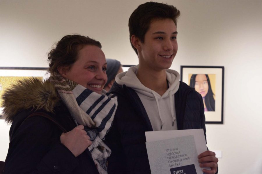 Junior Koji Gutzmann and US Photography and Video Arts teacher Stefanie Motta posing for a congratulatory photo. 