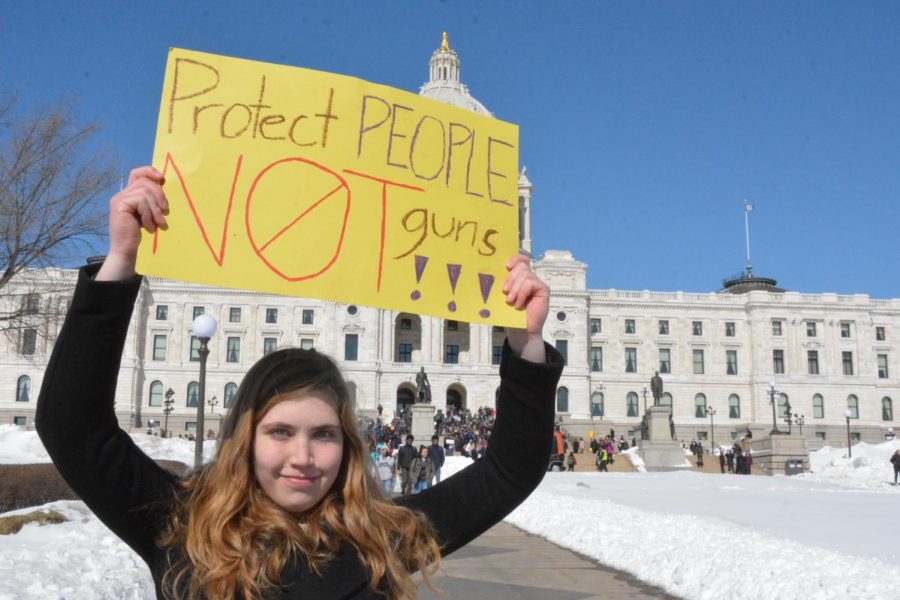 Sophomore Sydney Therien holds a pro-gun control sign in front of the capitol. "Gun control is what we need to focus on, and we want the legislature to hear that," Therien said.