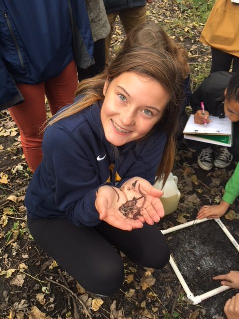 Junior Bailey Donovan holds worms that she collected for a sample.