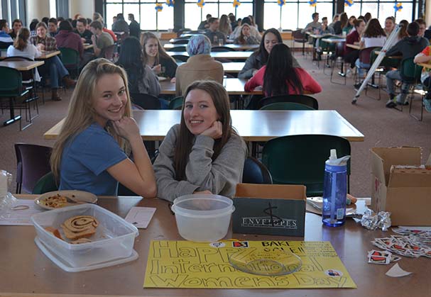 Seniors Erin McNamer and Isabel Brandtjen host a bake sale in the cafeteria to commemorate International Womens Day. 