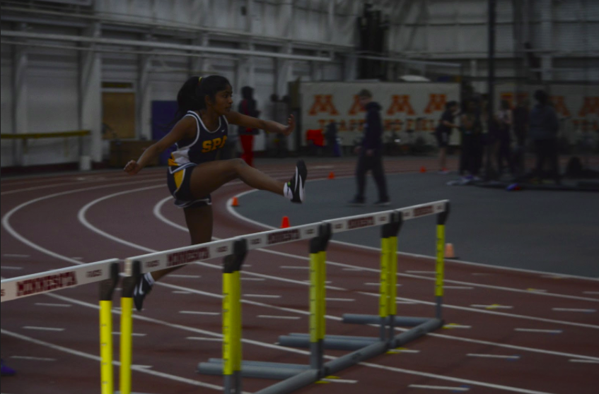 Ninth grader Rashmi Raveendran jumps a hurdle. Raveendran, Becca Richman, Sara Browne, and Olivia Lagos finished 2nd place in the 4x400m relay. 