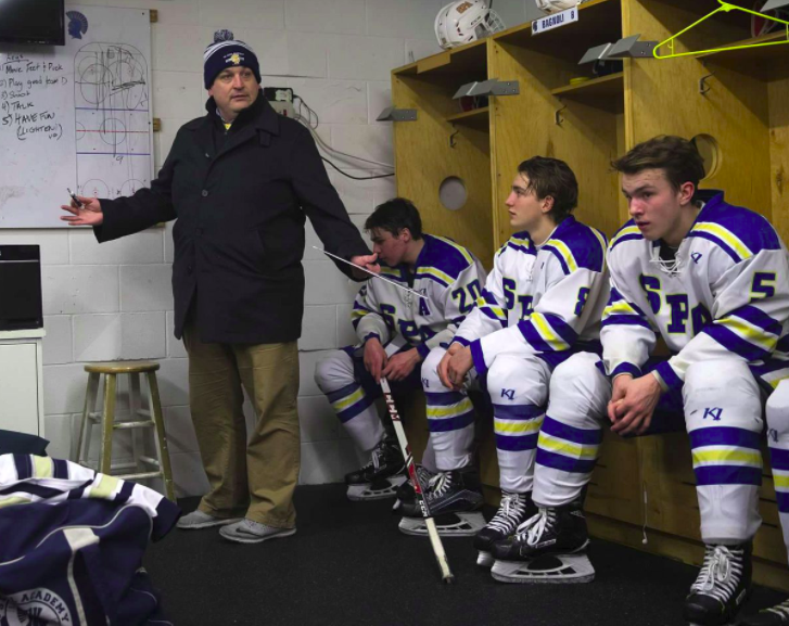 Former head coach Matt Funk coaches between periods during a game against Virginia High School.