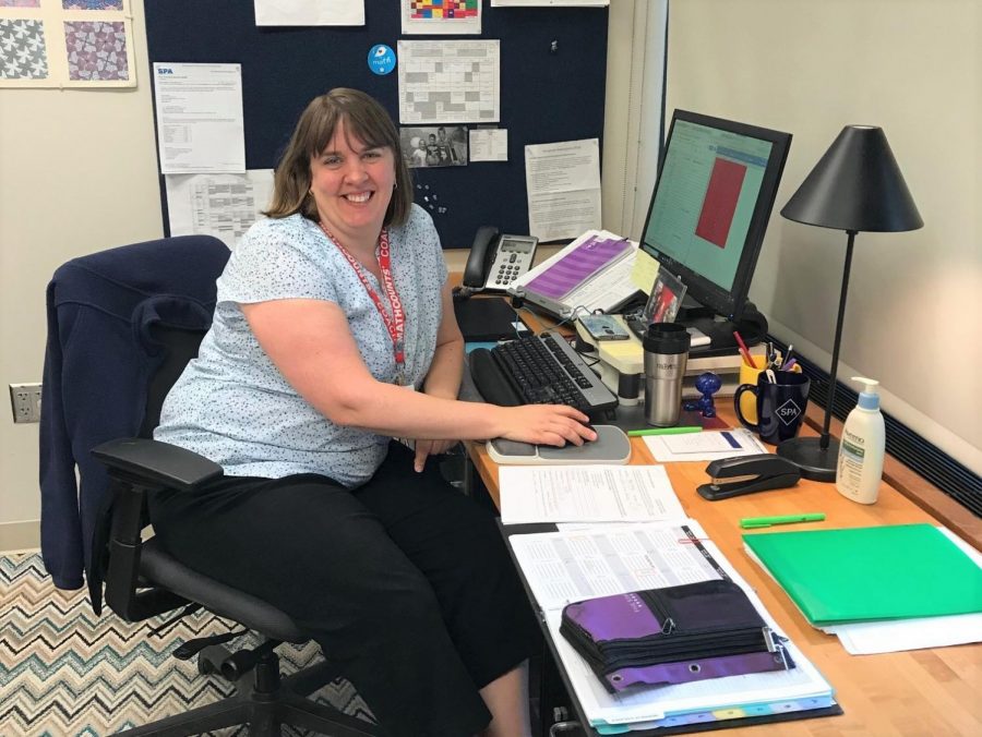 MS math teacher Jenny Borovsky sits at her desk surrounded by paper. "The middle school has six classes in six periods so there is no wiggle room like there is in the upper school," Borovsky said.