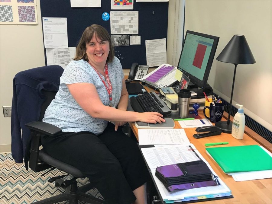 MS math teacher Jenny Borovsky sits at her desk surrounded by paper. The middle school has six classes in six periods so there is no wiggle room like there is in the upper school, Borovsky said.