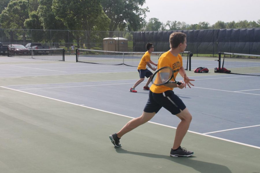 Senior Duke Nguyen returns his opponents serve.