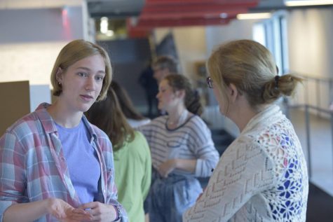 Junior Maggie Hlavka ex;ains her research to Assistant Head of School for Student Development and Community Engagement Jill Romans.