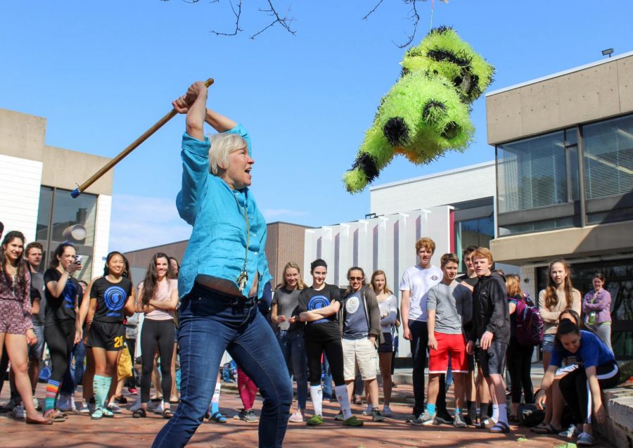 US Spanish teacher Pam Starkey readies an overhead blow on the piñata.