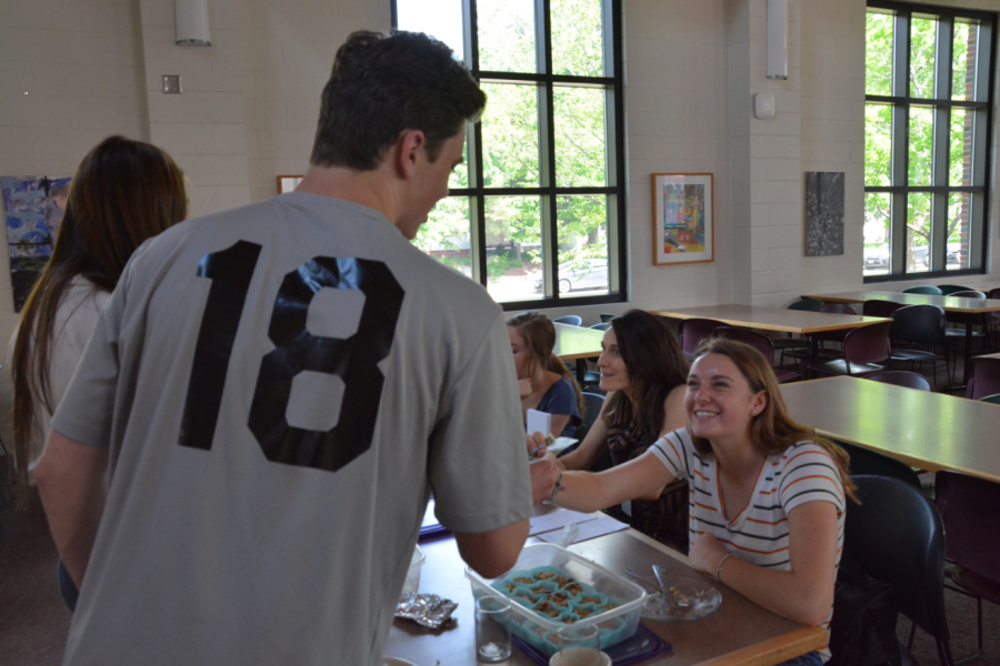 SADD co-president Jane Brunell takes money from junior Jasper Green for a baked good. 