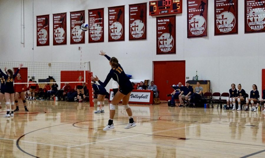 Senior and captain Blythe Rients serves a jump serve against Visitation. 