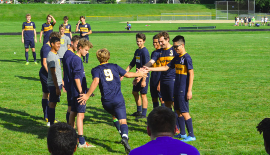 Senior Adam Zukowski sprints out to the field as his name is announced. 