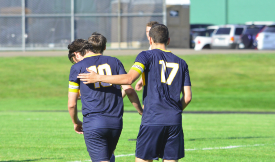 Senior Eric Lagos congratulates teammate senior Michael Forsgren after his second goal. 