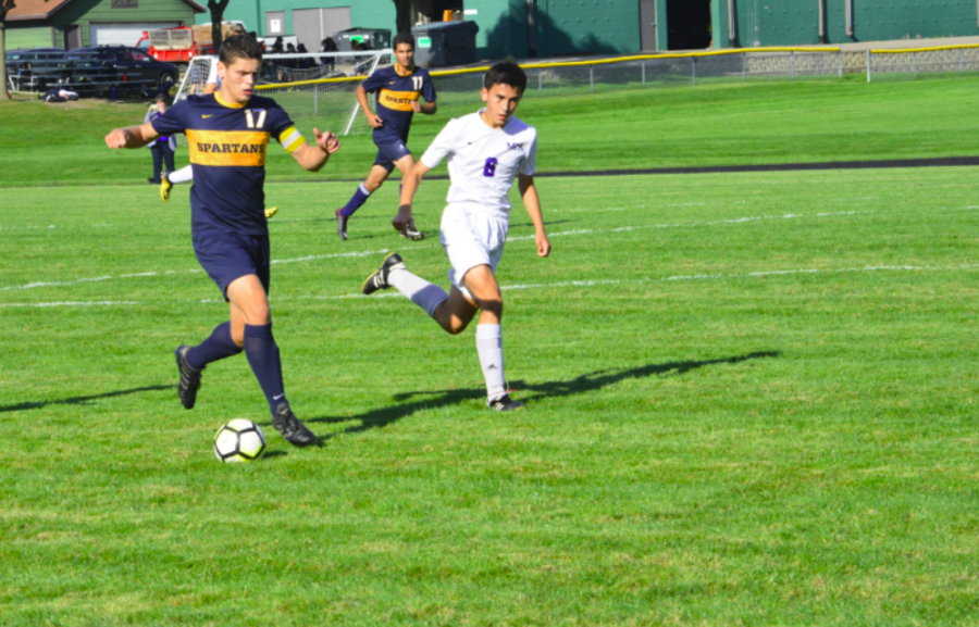Senior Eric Lagos dribbles the ball up the field. He scored twice in the game.