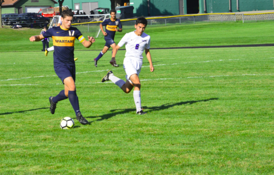 Senior Eric Lagos dribbles the ball up the field. He scored twice in the game. 