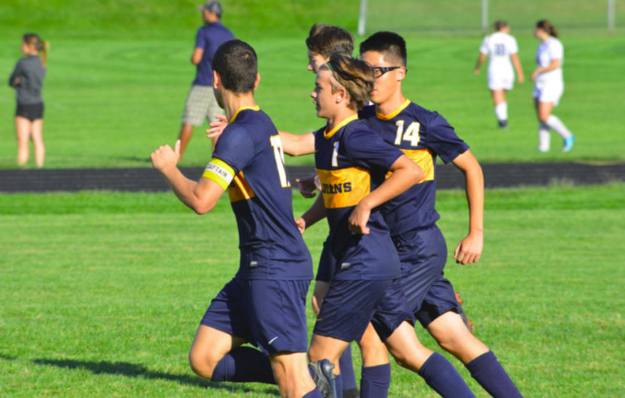 Team mates celebrate after Eric Lagos scores his first goal.