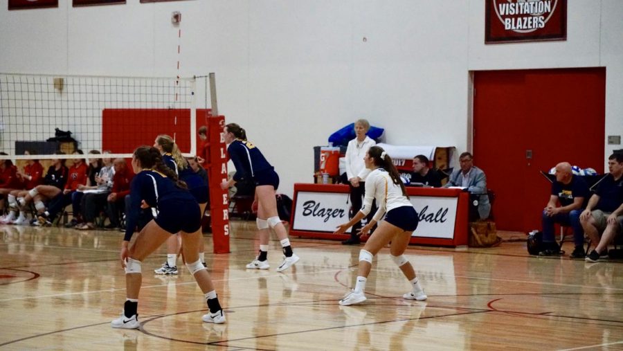 The SPA Girls Varsity Volleyball readies for defense against Visitation. 