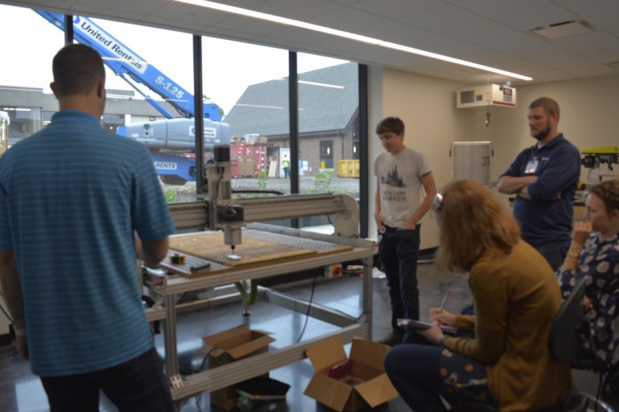 Students and faculty learn how to use the drill press. 