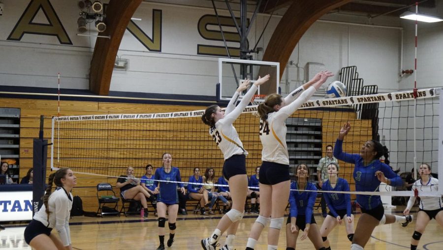 Junior Audrey Egly and junior and captain Kathleen Bishop block the ball against Blake on Sept. 14. 