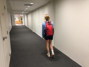 Senior Muriel Lang carries everything she needs down a halway formerly filled with lockers. 