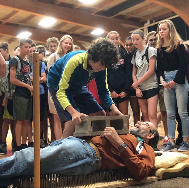 Dr. Heilig performs his famous 'bed of nails' demonstration at the Science Alliance booth.